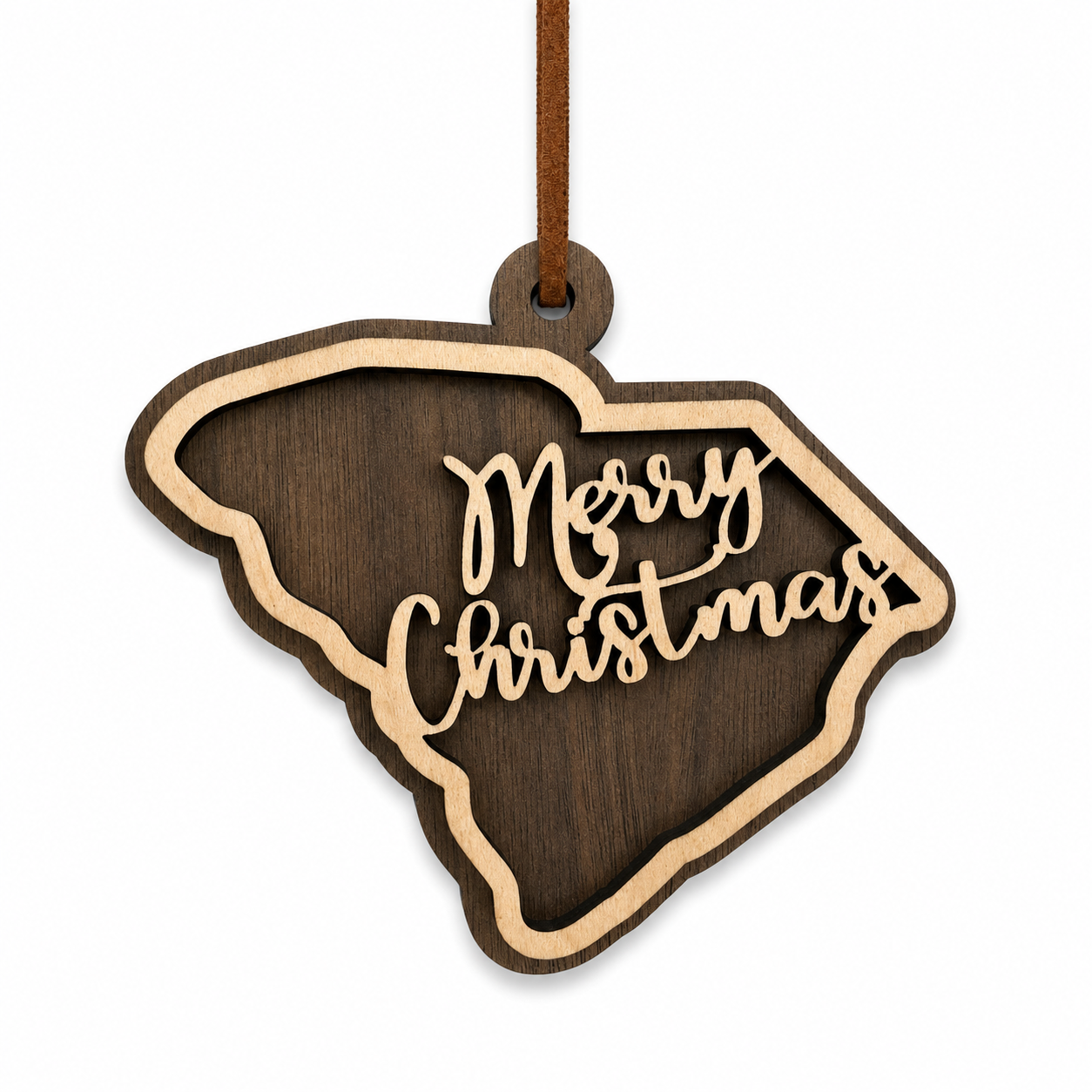 Layered South Carolina state Christmas ornament with walnut and maple wood and “Merry Christmas” script, photographed on a clean white background with faux leather hanger.