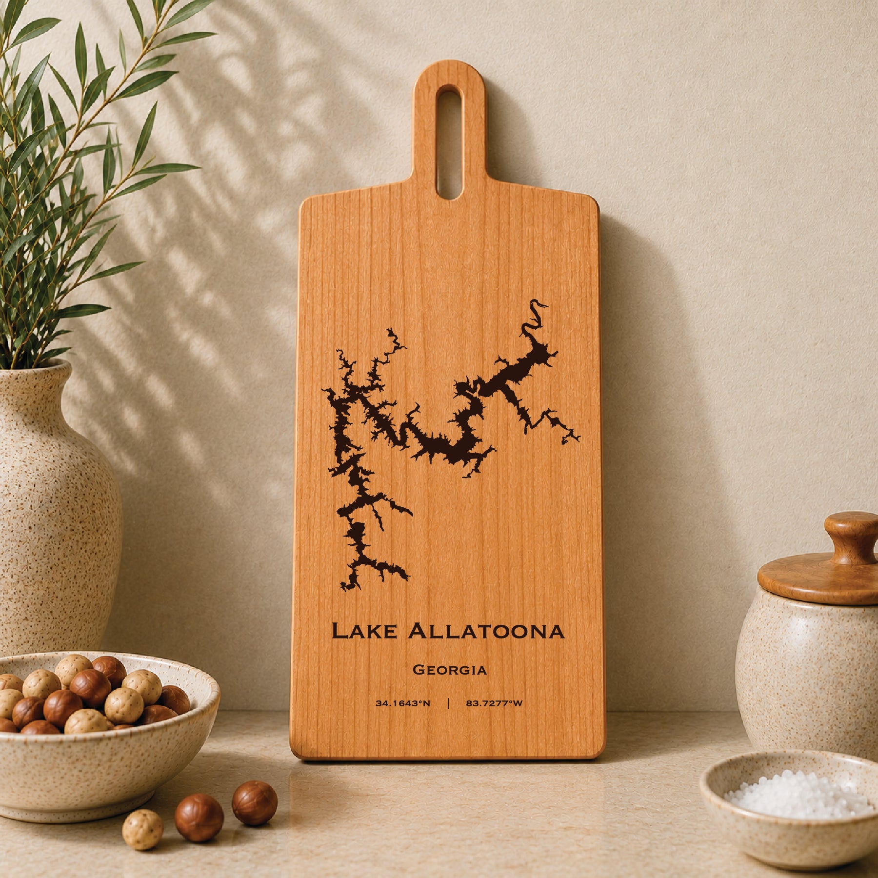 Lake Allatoona engraved serving board displayed on a neutral kitchen countertop with ceramic decor