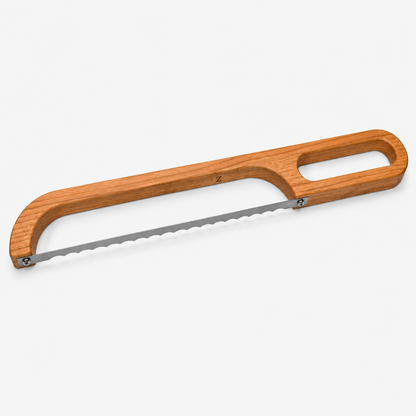 Cherry hardwood bread bow knife photographed at an angle on a white background showing the full open-frame handle and serrated stainless steel blade.