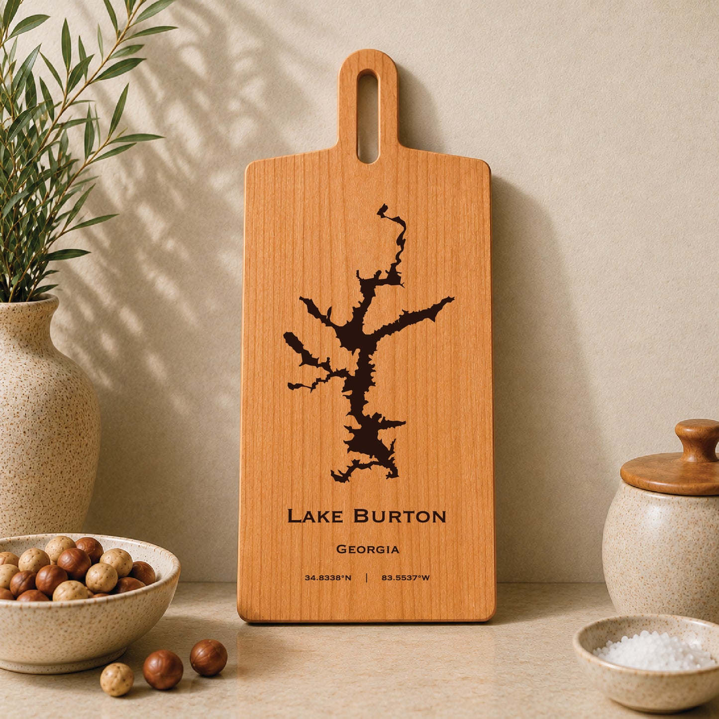 Lake Burton engraved serving board displayed on a neutral kitchen countertop with ceramic decor