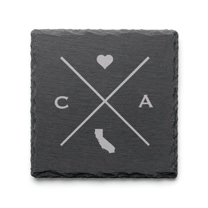 Dark slate coaster with engraved California crossed-line design, heart icon, and California silhouette on a dark background.