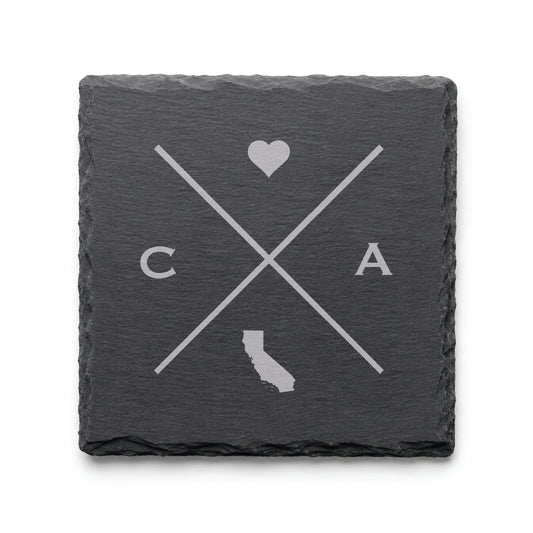 Dark slate coaster with engraved California crossed-line design, heart icon, and California silhouette on a dark background.