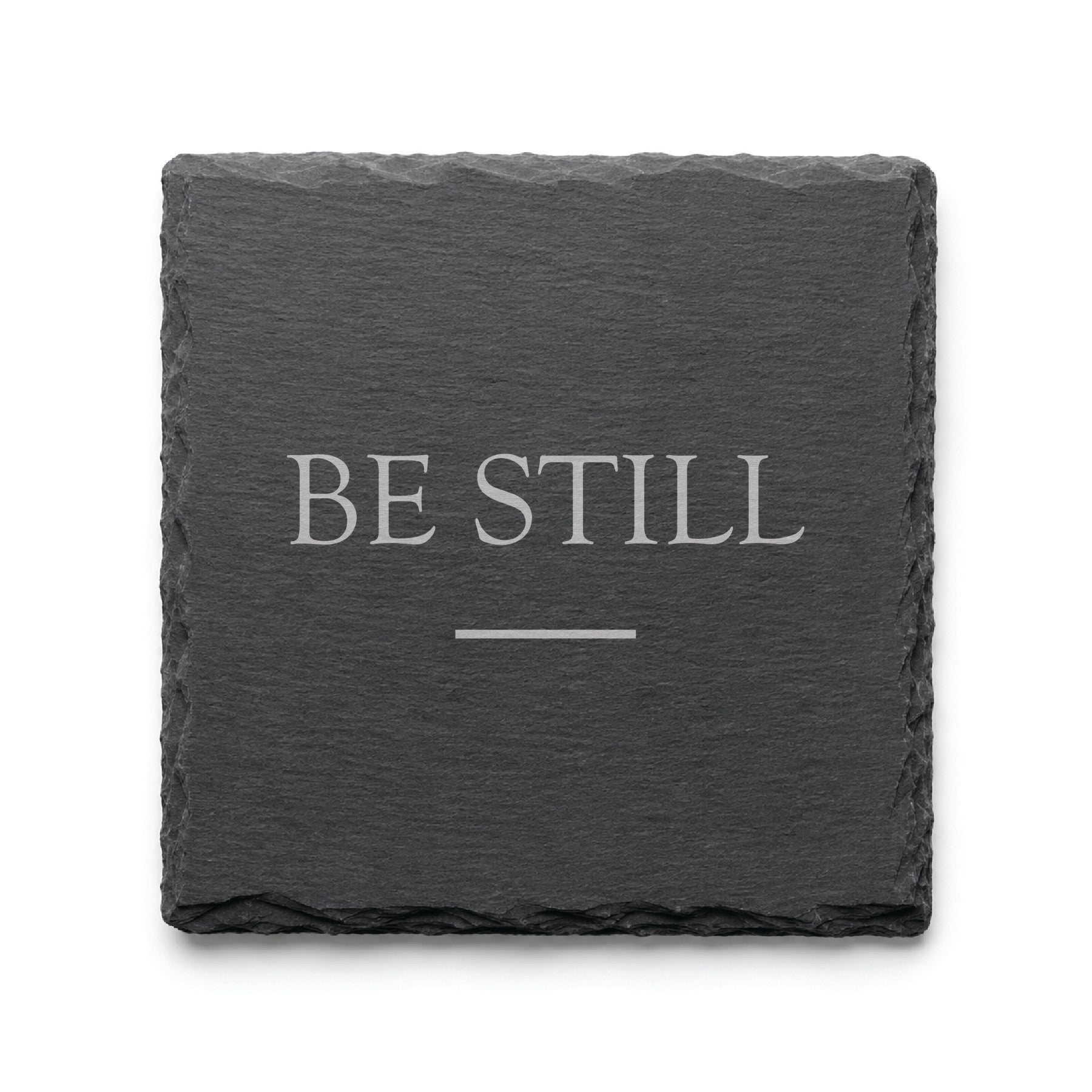 Black slate coaster engraved with the inspirational phrase Be Still and a minimalist accent line.