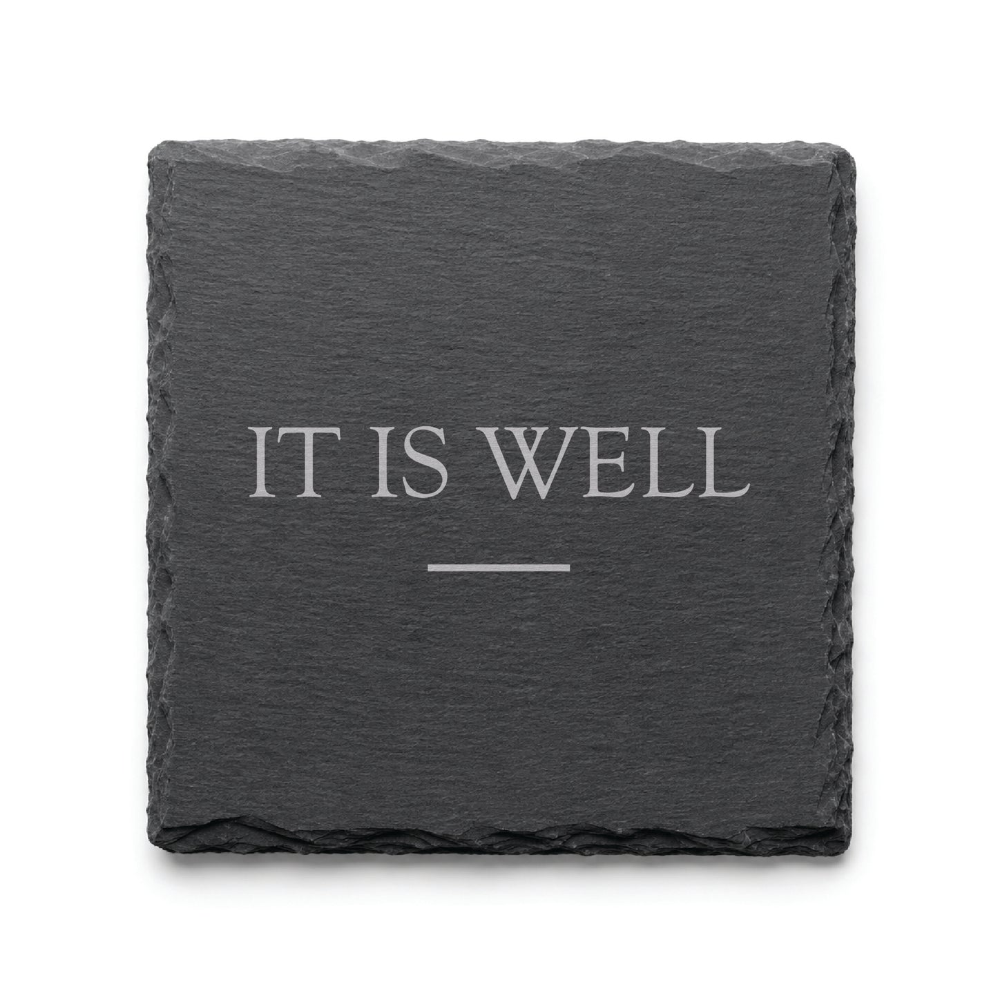 Black slate coaster engraved with the phrase It Is Well and a simple decorative line.