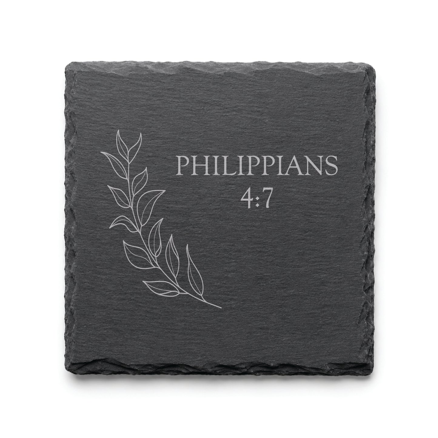 Black slate coaster engraved with Philippians 4:7 alongside a delicate botanical leaf illustration.