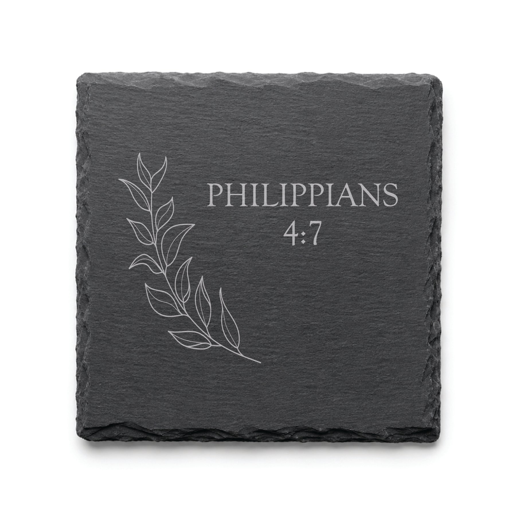 Black slate coaster engraved with Philippians 4:7 alongside a delicate botanical leaf illustration.