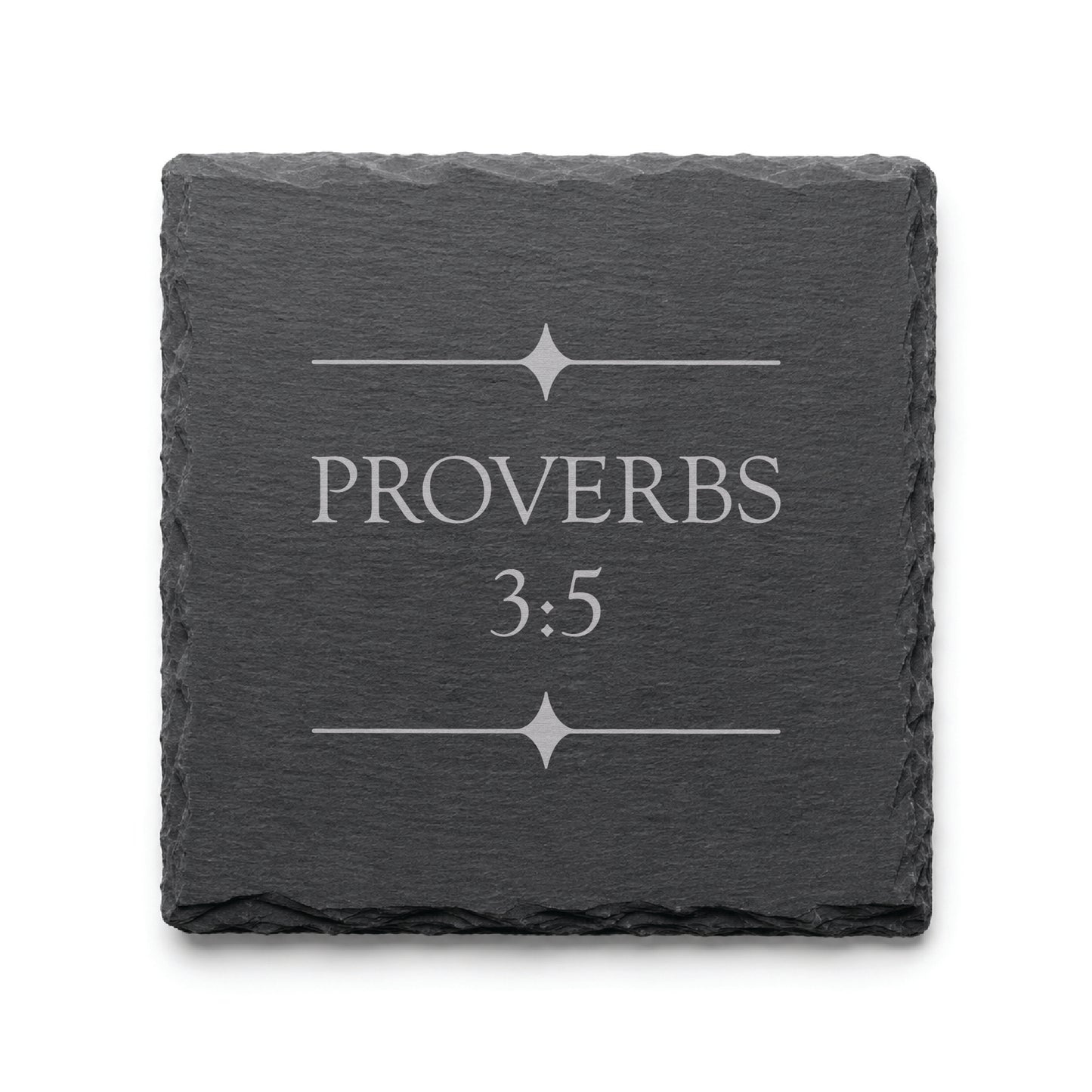 Black slate coaster engraved with Proverbs 3:5 and decorative starburst divider elements.