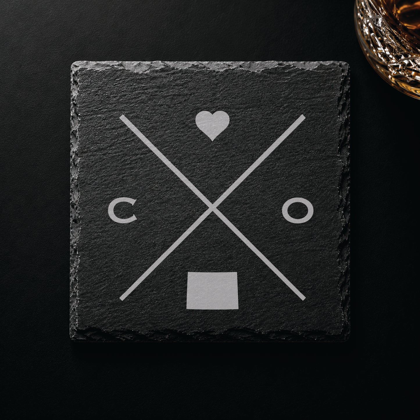 Engraved Colorado slate coaster featuring a minimalist crossed-line design with heart detail and Colorado silhouette on a clean light background.