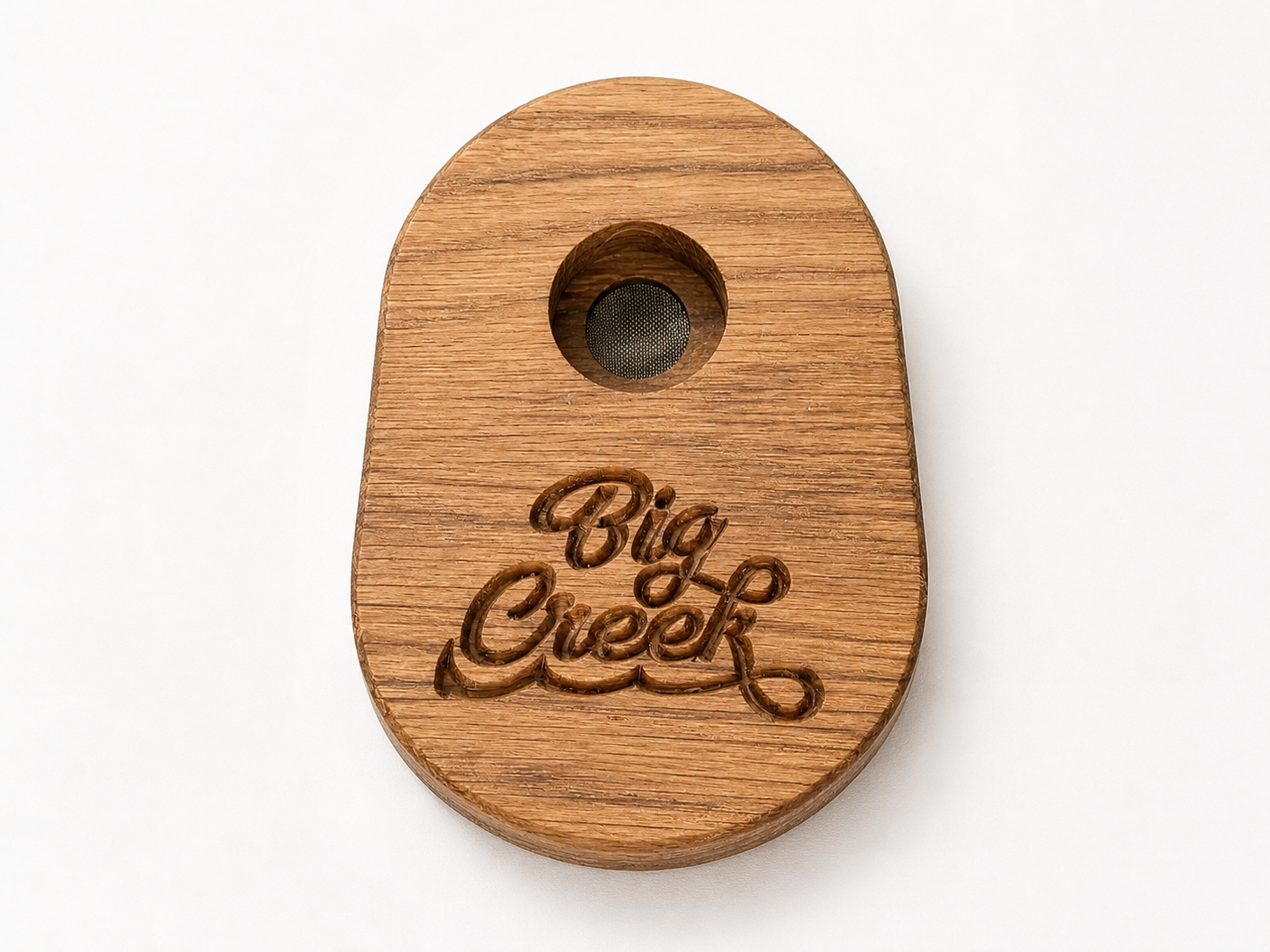 Wooden whiskey smoker with custom “Big Creek” engraved logo, round shape with center burn chamber and mesh screen.