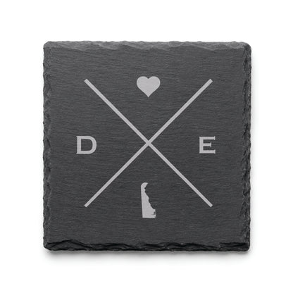 Engraved Delaware slate coaster featuring a minimalist crossed-line design with heart detail and Delaware silhouette on a clean light background.