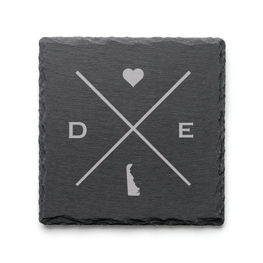Engraved Delaware slate coaster featuring a minimalist crossed-line design with heart detail and Delaware silhouette on a clean light background.