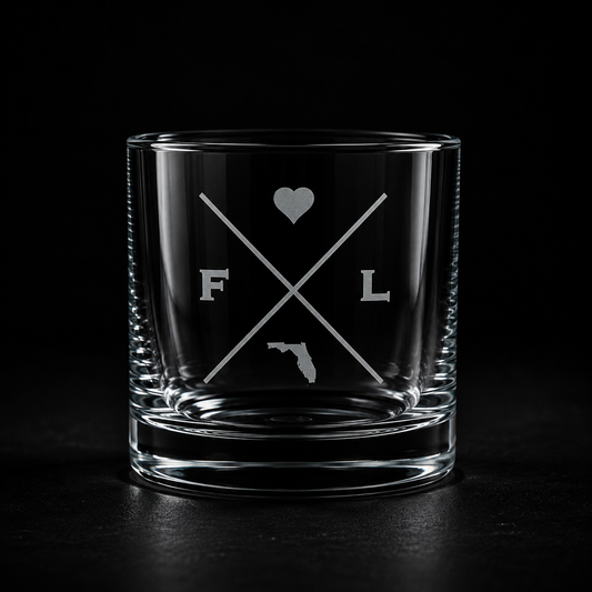 Engraved Florida rocks glass with frosted Florida silhouette and crossed-letter monogram on a dark background.