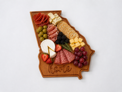 Georgia shaped wooden serving board styled with charcuterie including cheese, meats, nuts, and fruit
