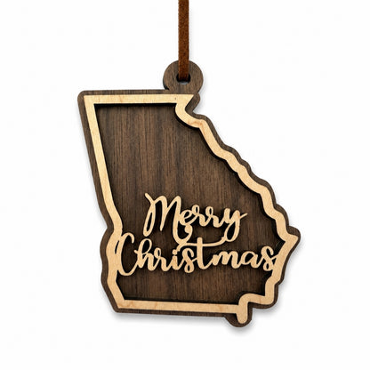 Wooden ornament shaped like the state of Georgia with 'Merry Christmas' text on a white background