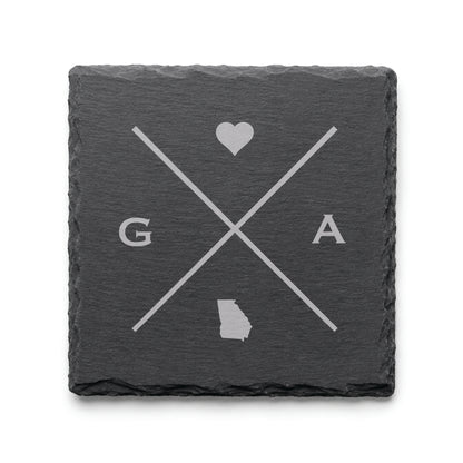 Engraved Georgia slate coaster featuring a minimalist crossed-line design with heart detail and Georgia silhouette on a clean light background.