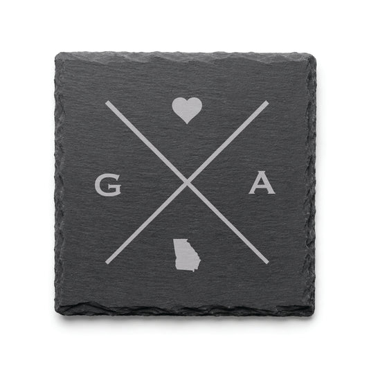 Engraved Georgia slate coaster featuring a minimalist crossed-line design with heart detail and Georgia silhouette on a clean light background.