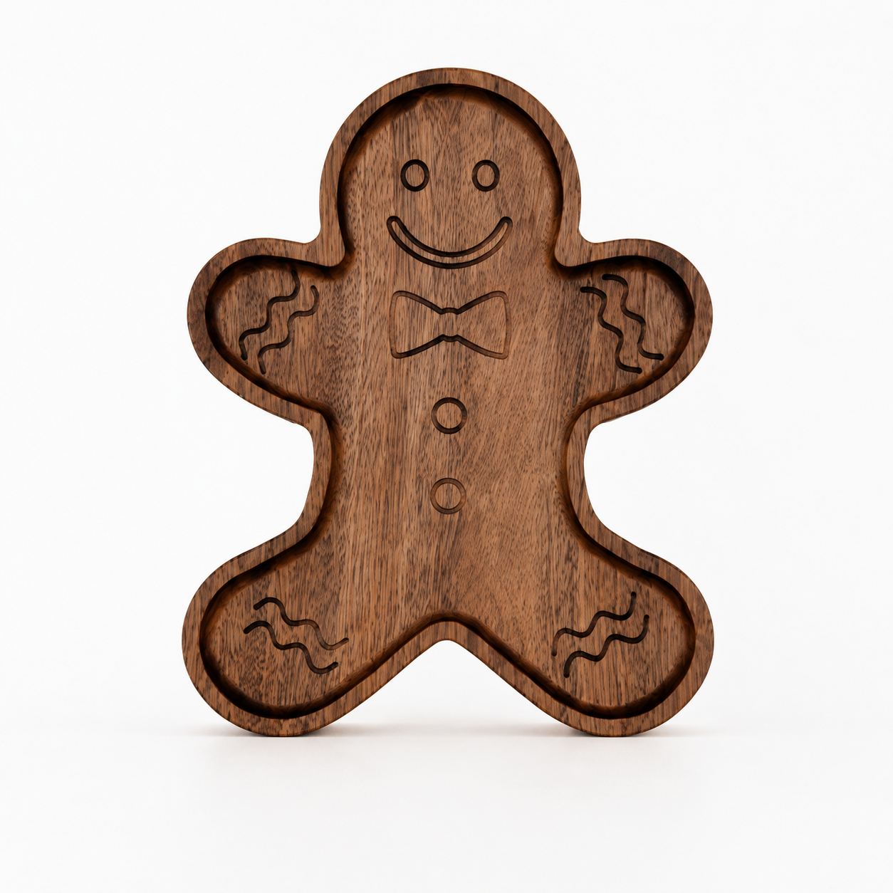 Gingerbread-shaped snack tray standing upright on a light neutral background, featuring engraved facial details and recessed compartments with smooth carved edges.