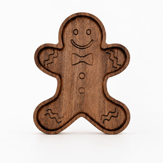 Gingerbread-shaped snack tray standing upright on a light neutral background, featuring engraved facial details and recessed compartments with smooth carved edges.