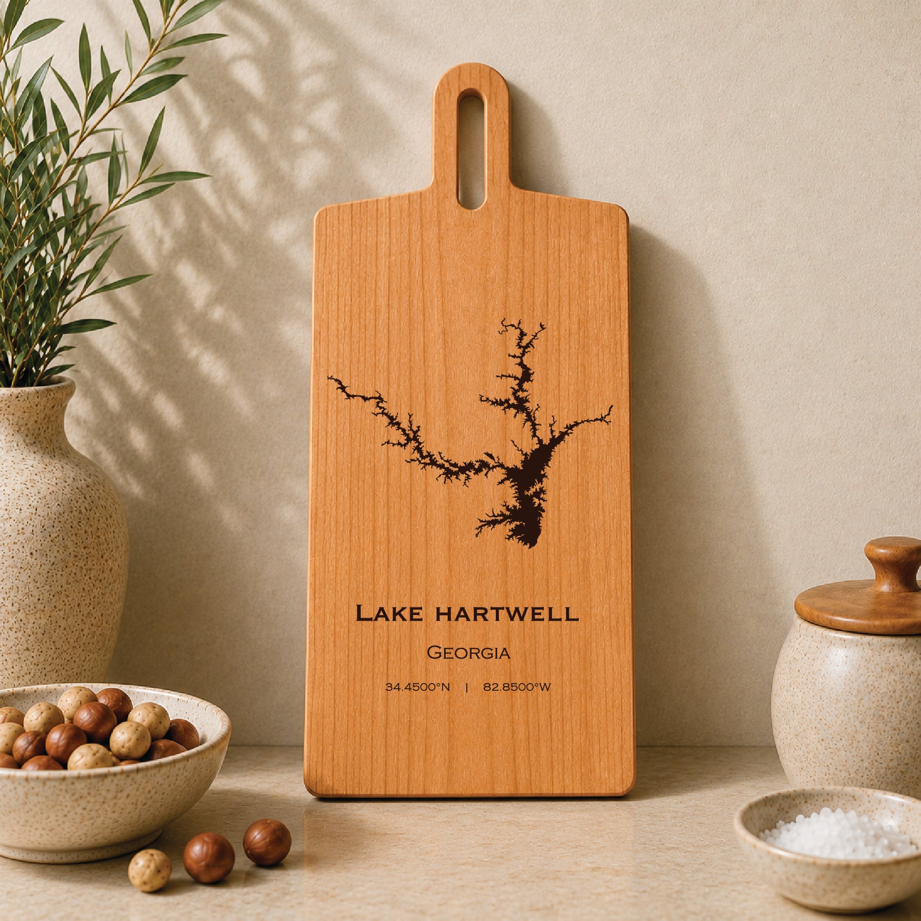 Lake Hartwell engraved serving board displayed on a neutral kitchen countertop with ceramic decor