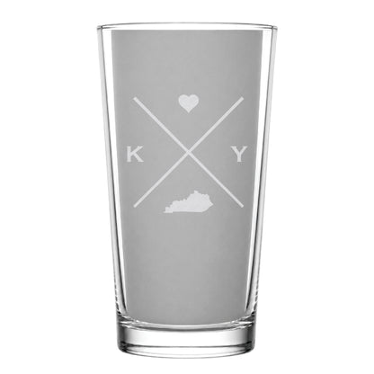 Clear pint glass with engraved Kentucky crossed-line design, heart icon, and Kentucky silhouette on a clean light background