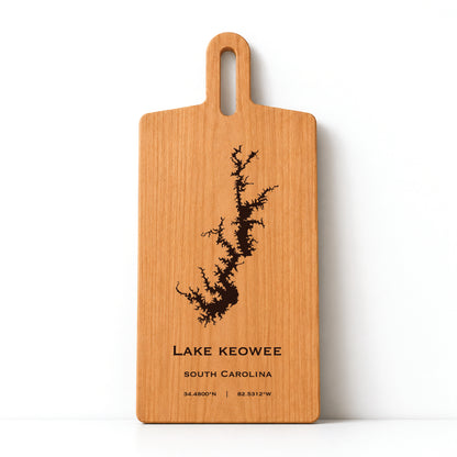 Minimal cherry wood serving board featuring engraved Lake Keowee shoreline and coordinates