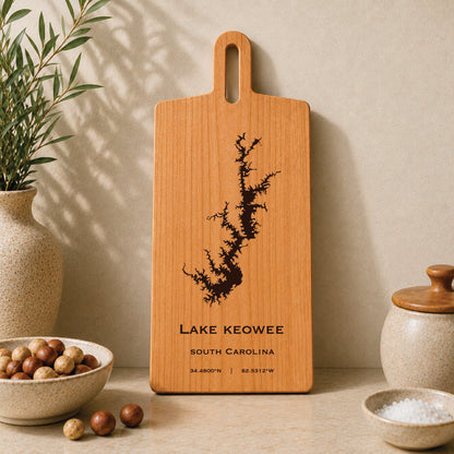 Lake Keowee engraved serving board displayed on a neutral kitchen countertop with ceramic decor