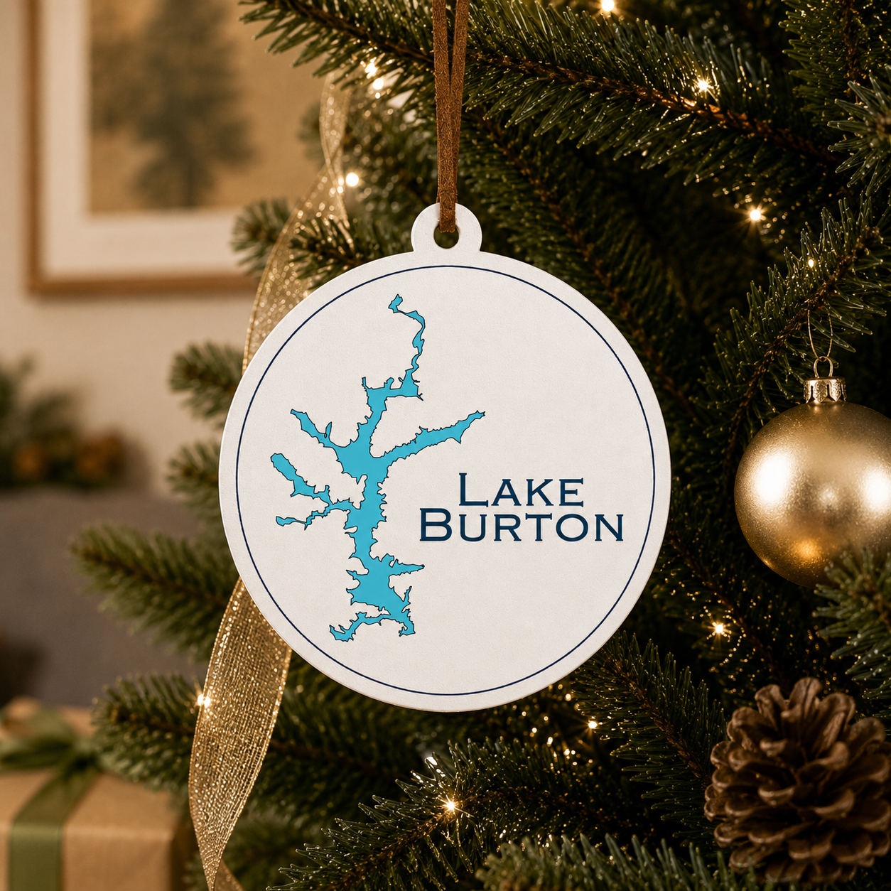 White Lake Burton ornament hanging on a decorated Christmas tree with warm lights and gold ribbon.