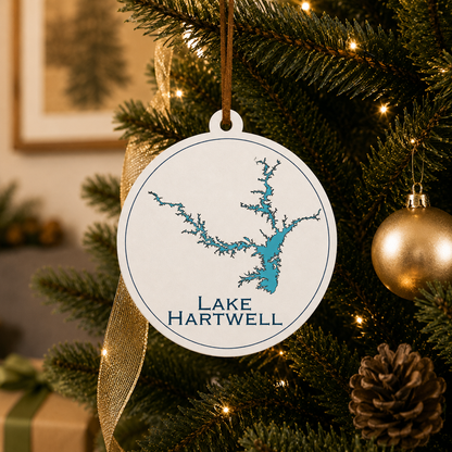 White Lake Hartwell ornament hanging on a decorated Christmas tree with warm lights and gold ribbon.
