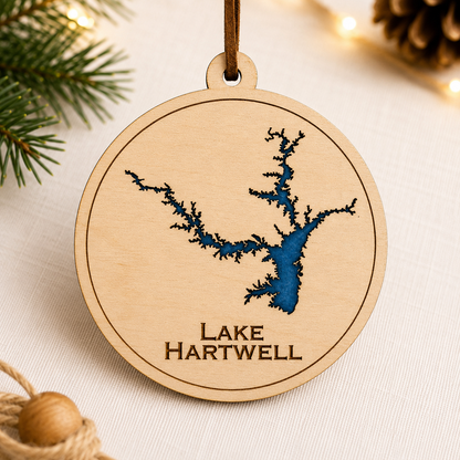 Close-up angled view of layered wood Lake Hartwell ornament showing dimensional lake design and engraved lettering.