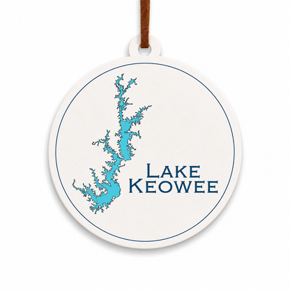 White Lake Keowee ornament with blue lake map design and brown hanging cord on a clean light background.