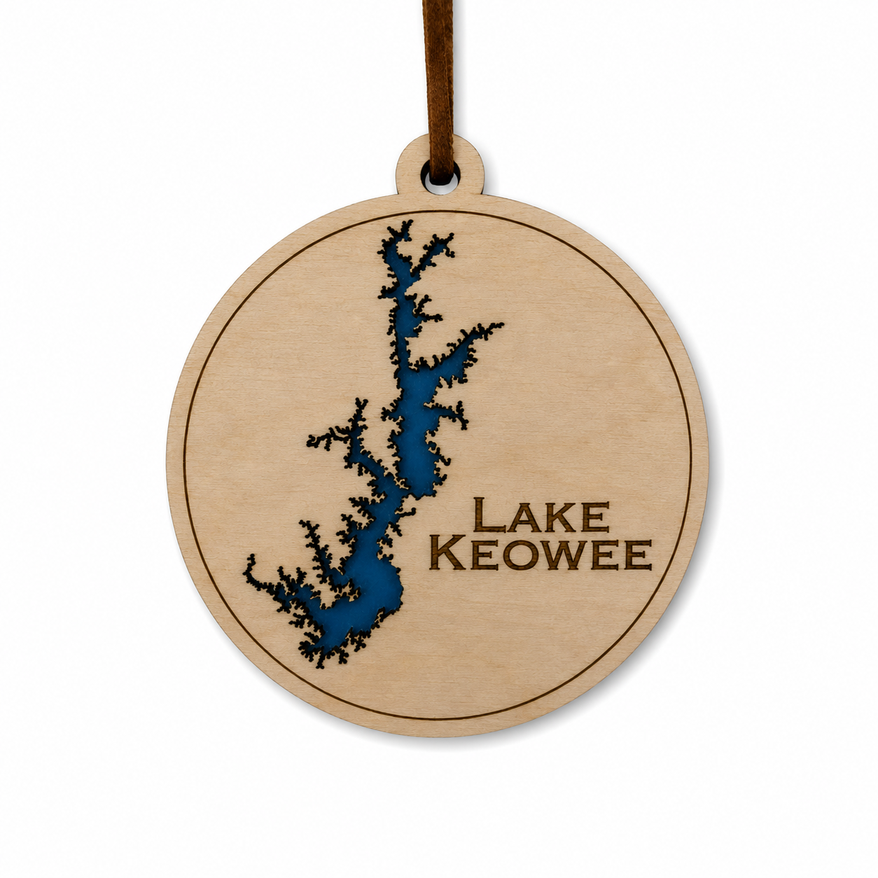 Layered wood Lake Keowee ornament with blue lake detail and brown hanging cord on a clean light background.
