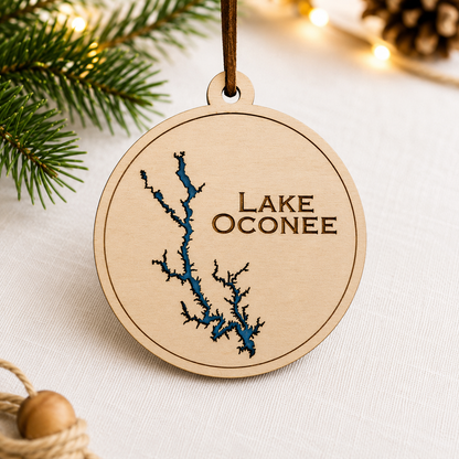 Close-up angled view of layered wood Lake Oconee ornament showing dimensional lake design and engraved lettering.