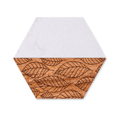Hexagon faux marble and acacia wood coaster featuring an engraved falling leaves pattern on a white background.