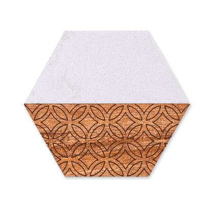 Single hexagon marble and acacia wood coaster shown on a white background, featuring a geometric engraved pattern on the wood half and a smooth white marble half.