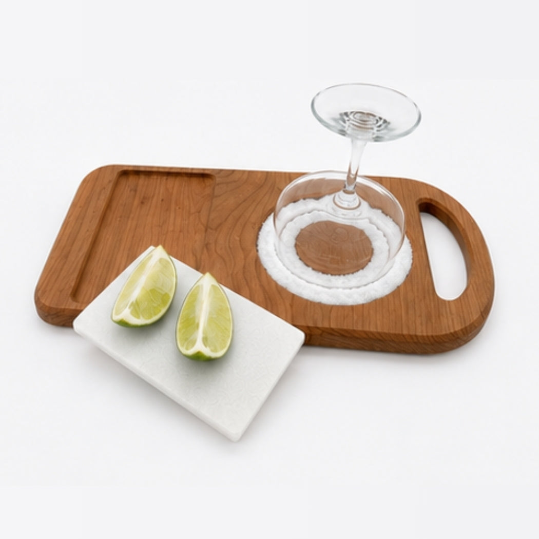 Front angle view of cherry wood margarita rimmer featuring removable marble lime cutting tile and salt rimmer.