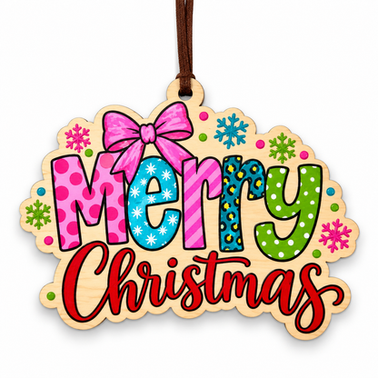A wooden Christmas ornament with a natural wood border and a hanging loop, featuring the words 'Merry Christmas' in colorful patterned letters with snowflake and polka dot accents on a white background.