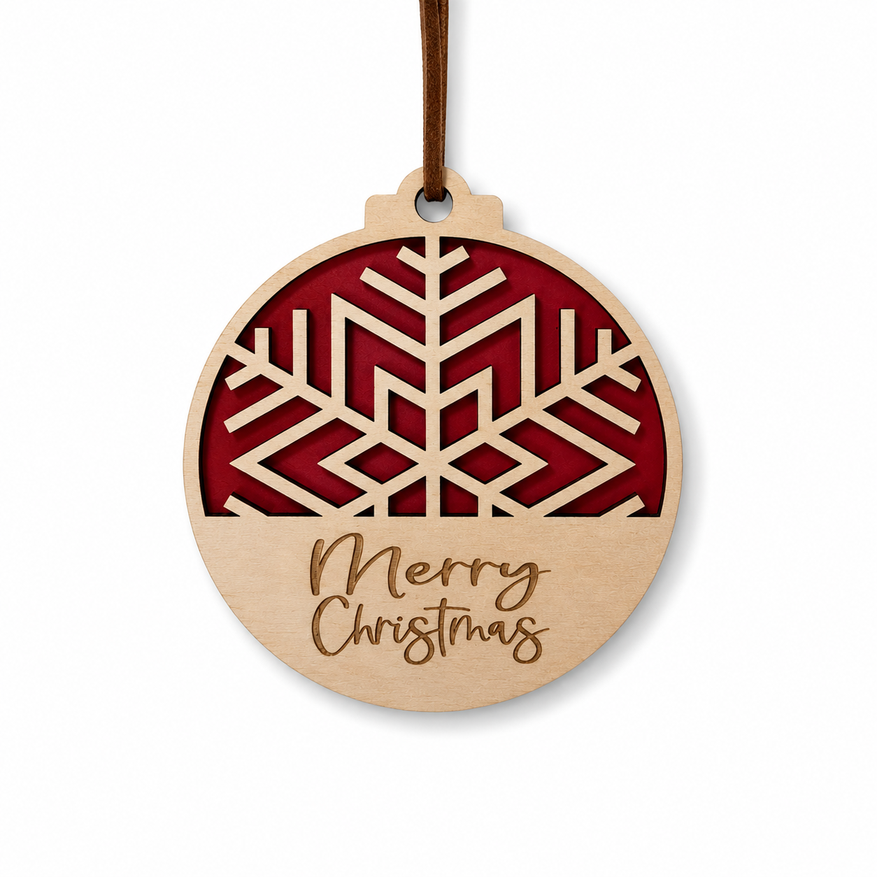 Geometric snowflake Christmas ornament with layered red background, engraved Merry Christmas text, and faux leather hanger on light gray background