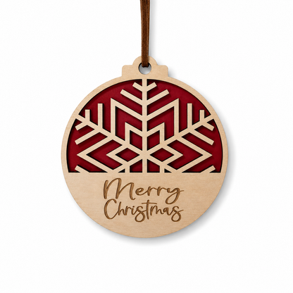 Geometric snowflake Christmas ornament with layered red background, engraved Merry Christmas text, and faux leather hanger on light gray background