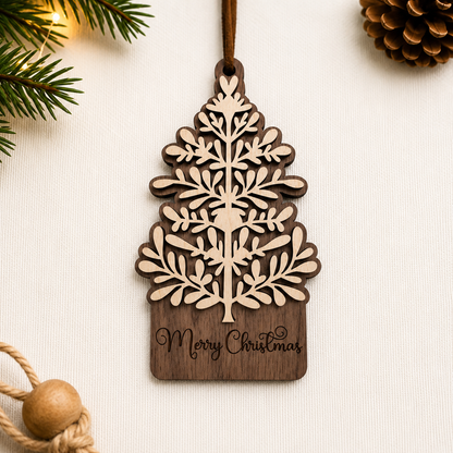 Walnut and maple layered Christmas tree ornament displayed on neutral fabric background