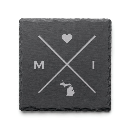 Engraved Michigan slate coaster featuring a minimalist crossed-line design with heart detail and Michigan silhouette on a clean light background.