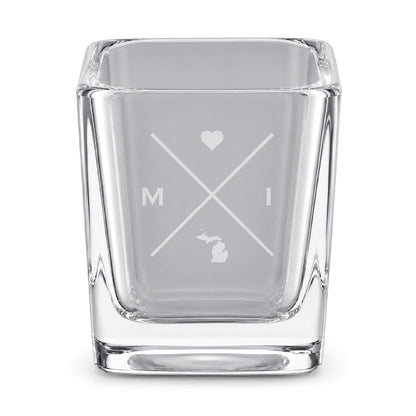 Clear engraved Michigan shot glass featuring a minimalist crossed-line design with heart detail and Michigan silhouette on a clean light background.