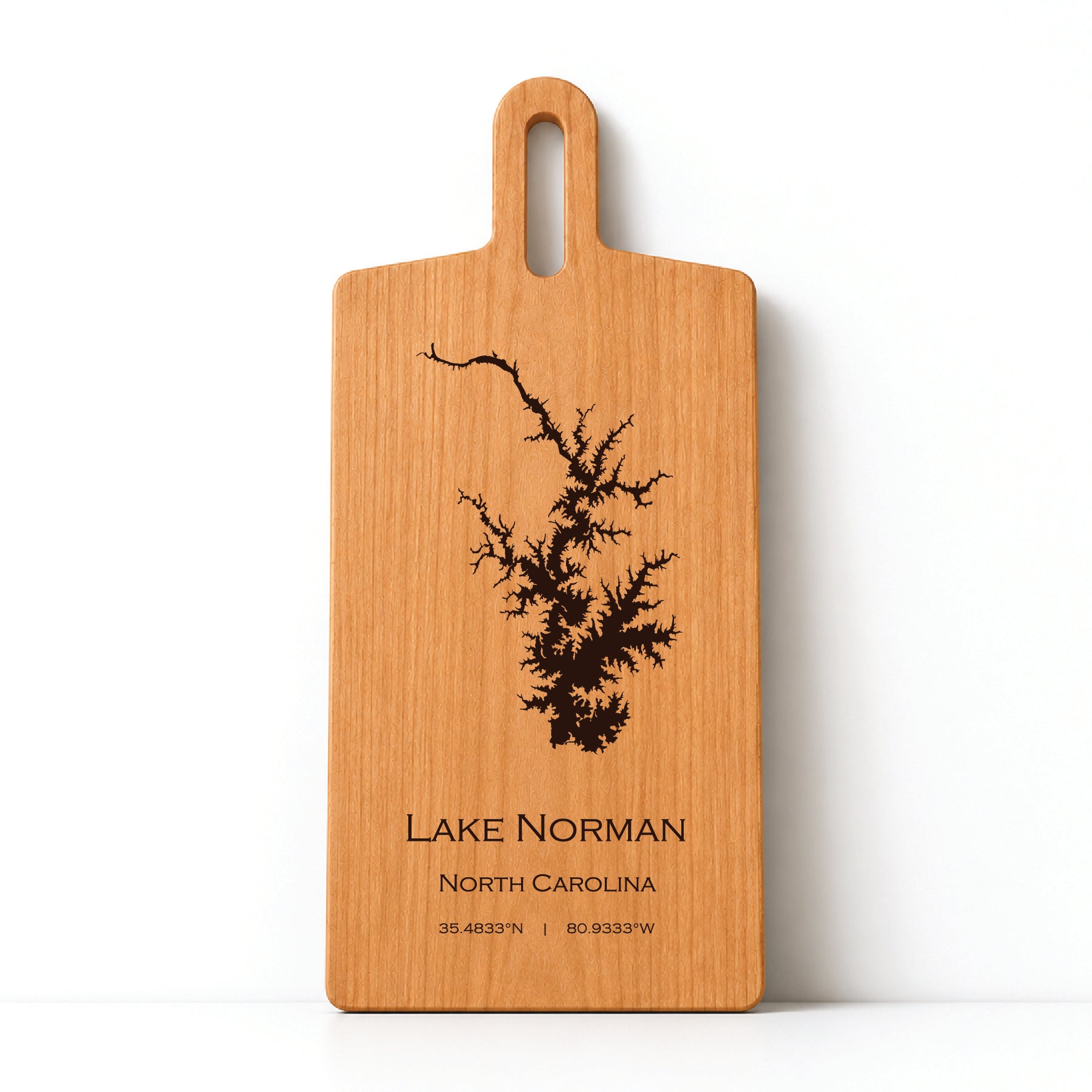 Minimal cherry wood serving board featuring engraved Lake Norman shoreline and coordinates