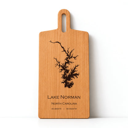 Minimal cherry wood serving board featuring engraved Lake Norman shoreline and coordinates