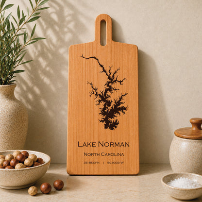 Lake Norman engraved serving board displayed on a neutral kitchen countertop with ceramic decor