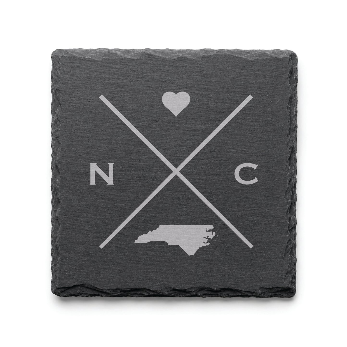Engraved North Carolina slate coaster featuring a minimalist crossed-line design with heart detail and North Carolina silhouette on a clean light background.