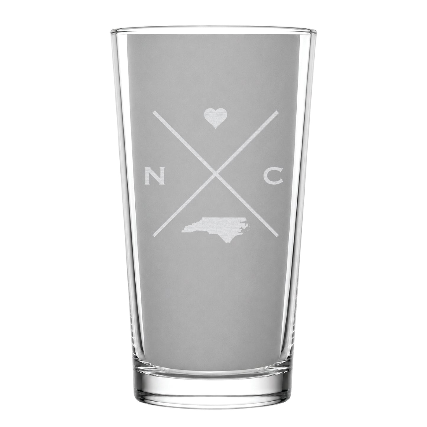 Clear pint glass with engraved North Carolina crossed-line design, heart icon, and North Carolina silhouette on a clean light background