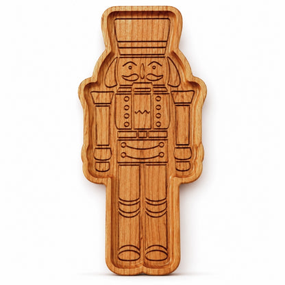 Cherry hardwood nutcracker serving tray standing upright on a clean white background with detailed engraved nutcracker design