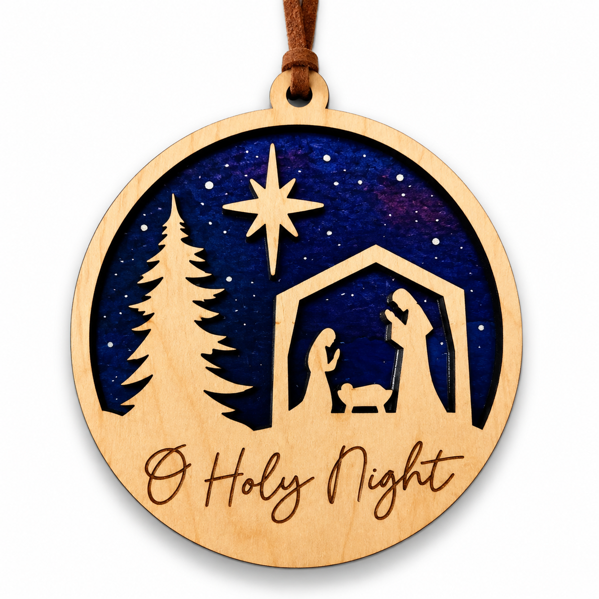 A round wooden Christmas ornament with a hanging loop, featuring a laser-cut nativity scene with a star, tree, stable, and the words 'O Holy Night' on a white background.