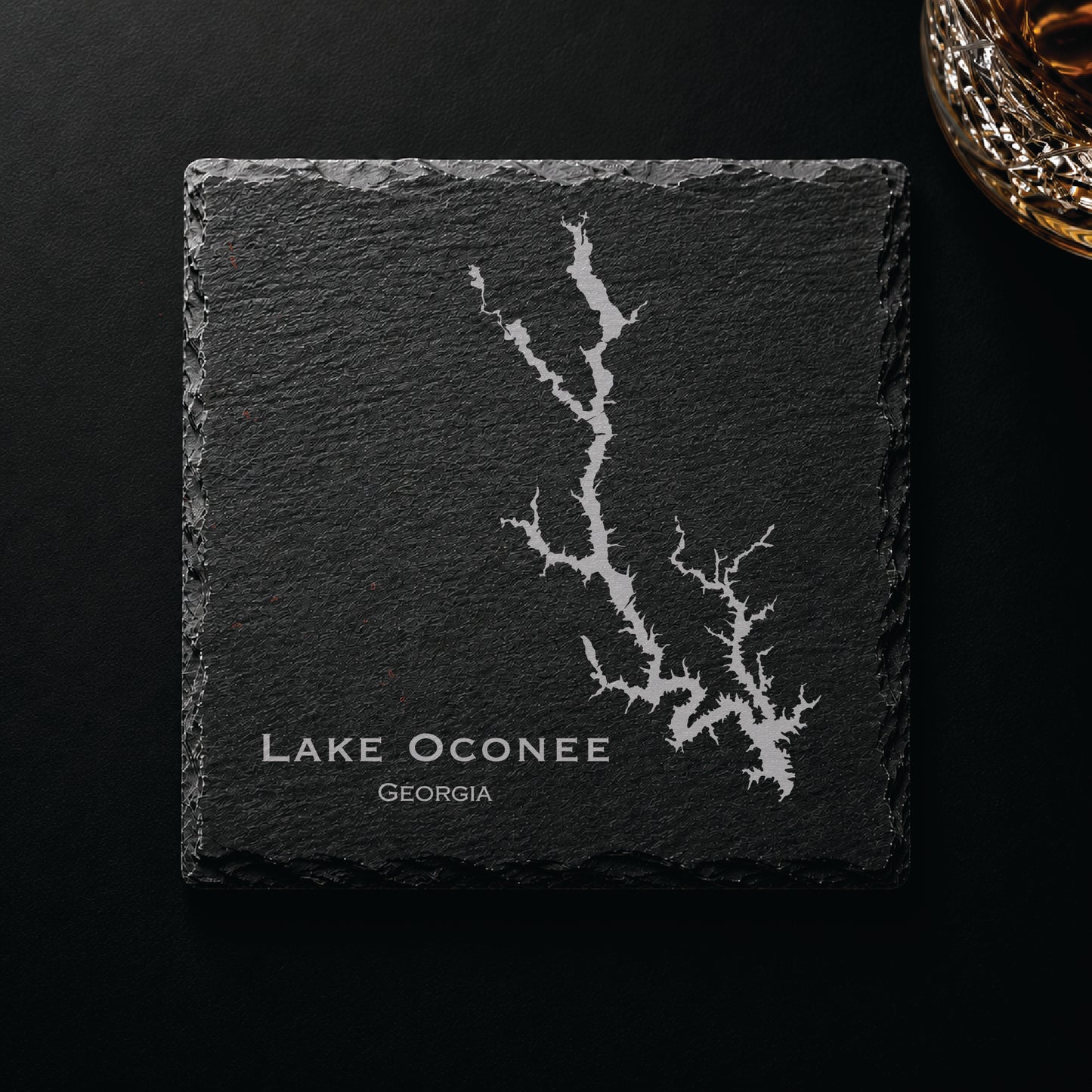 Dark slate coaster engraved with a detailed Lake Oconee map and Georgia text on a dark background.