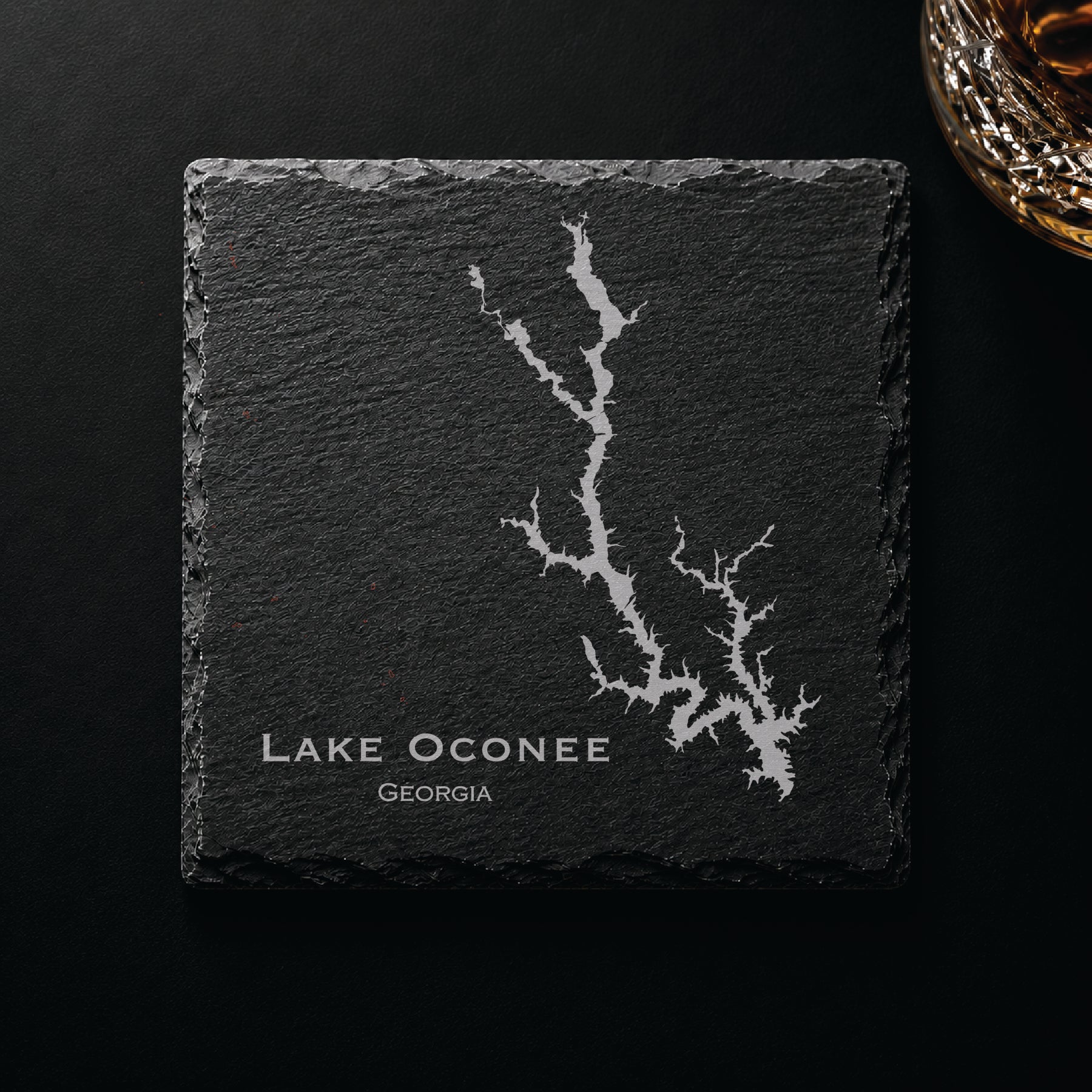 Dark slate coaster engraved with a detailed Lake Oconee map and Georgia text on a dark background.